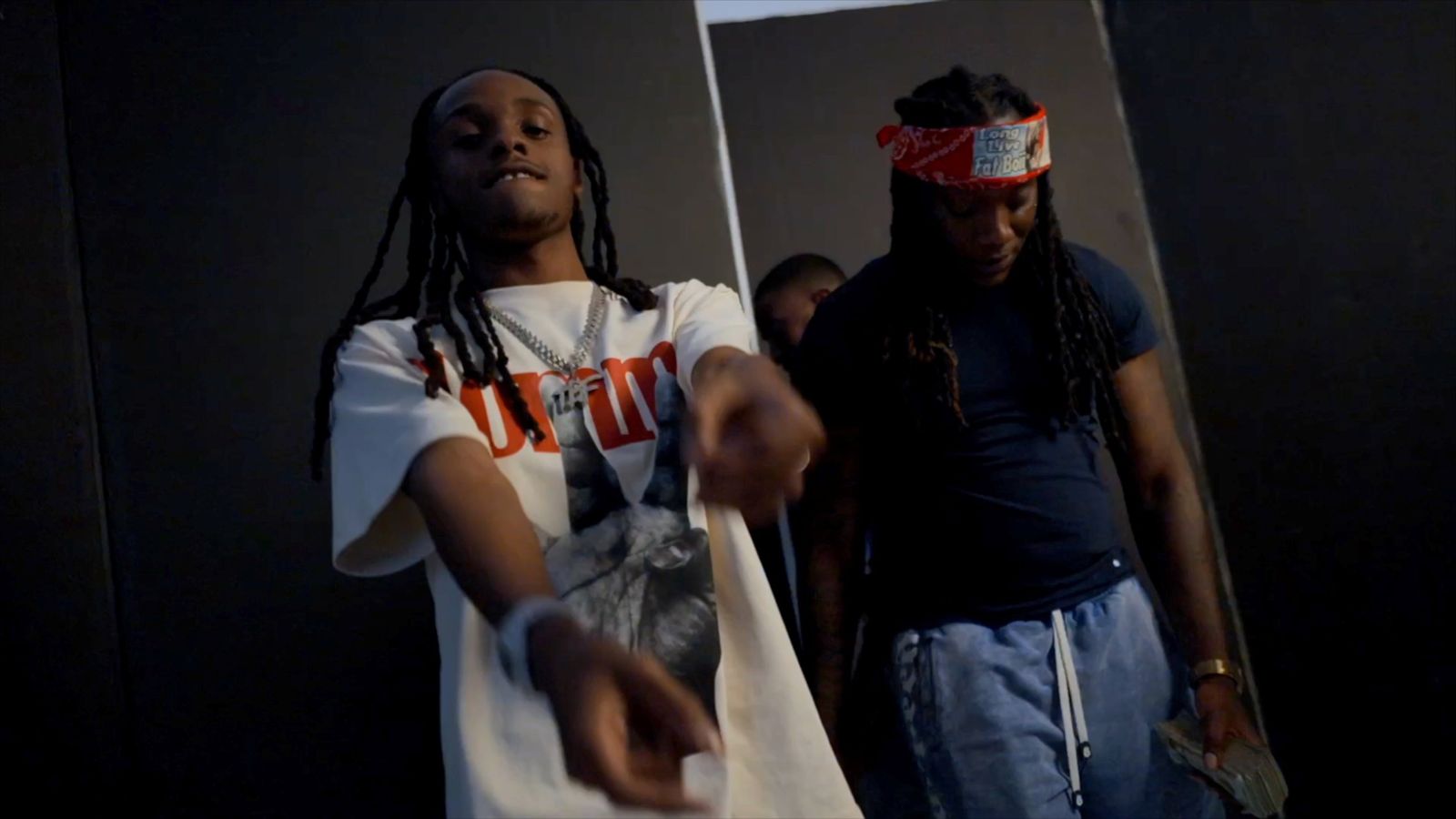 TorchBinFinessin pointing at the camera beside 6 Babyy on the Bin Thru set