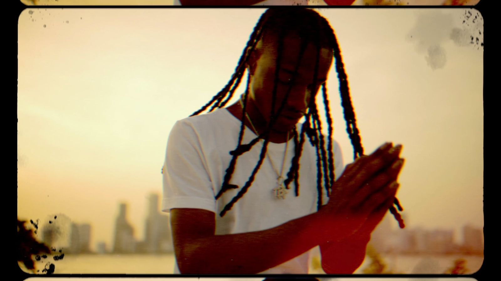 Torch at sunset on the Miami waterfront, hands together, from the Rain video